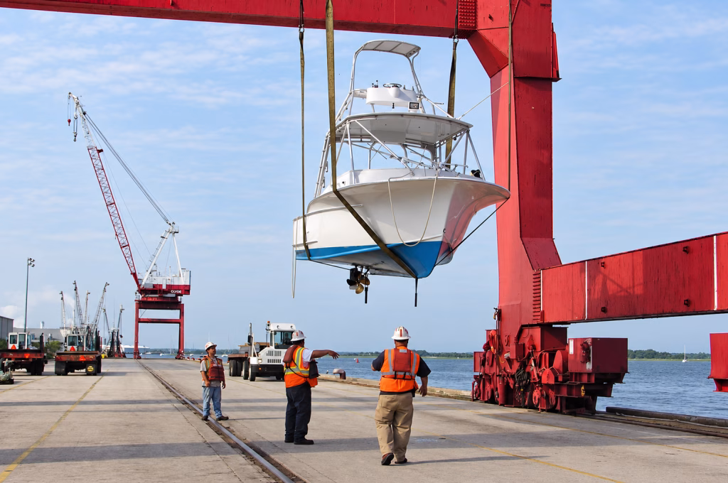 Sport fishing boat lifted by a gantry crane at a port for international shipping